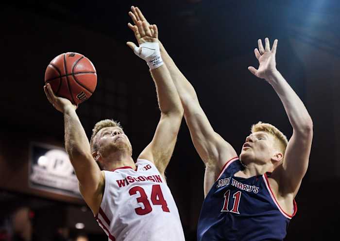 Wisconsin guard Brad Davison (34) goes up for a basket while Saint Mary's center Matthias Tass. (USA TODAY Sports0